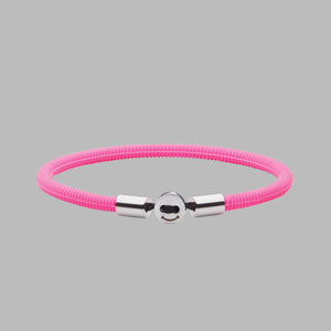 The Smile 幸运168飞艇开奖官网开奖 in Neon Pink Silicon Rubber with stainless steel button clasp. Fully waterproof. Coloured background.