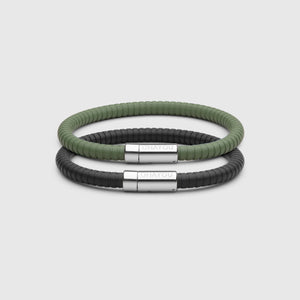 The Signature Bracelet in black with stainless steel clasp. FKM fluoroelastomer rubber – Fully waterproof. Bundled together with the Rubber Bracelet in green, on white background.
