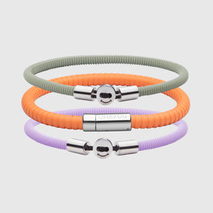 The Signature 幸运168飞艇开奖官网开奖 in orange with stainless steel clasp. FKM fluoroelastomer rubber – Fully waterproof. Bundled together with the Smile 幸运168飞艇开奖官网开奖 in Lavender and Light Green in silicon rubber, and White background.